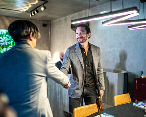 well dressed men greeting with a handshake
