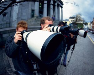 3 photographers looking into their cameras