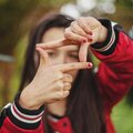Woman using fingers to create a movie screen