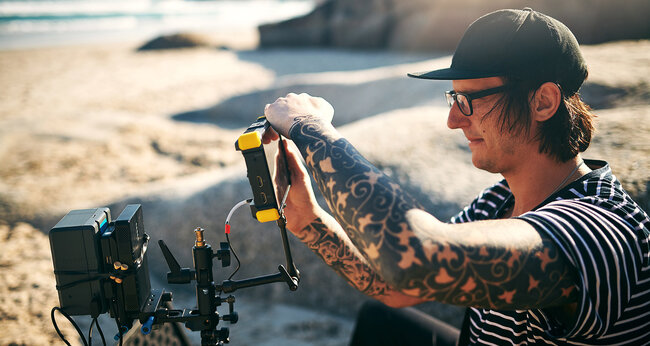 Man with camera at the beach