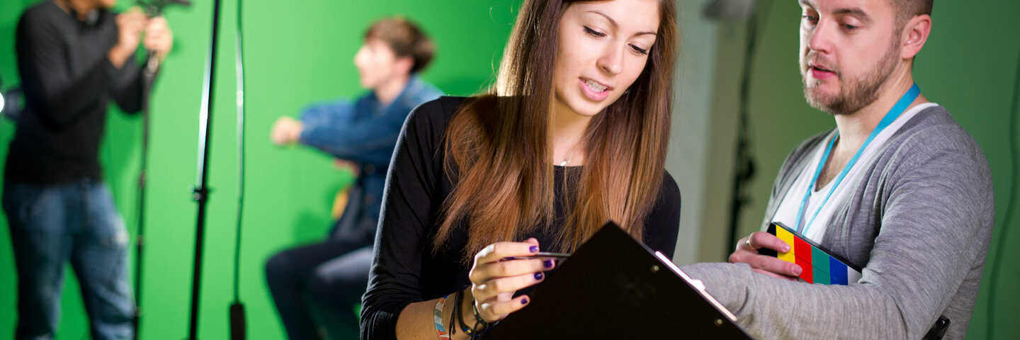 Two producers discussing shot list.