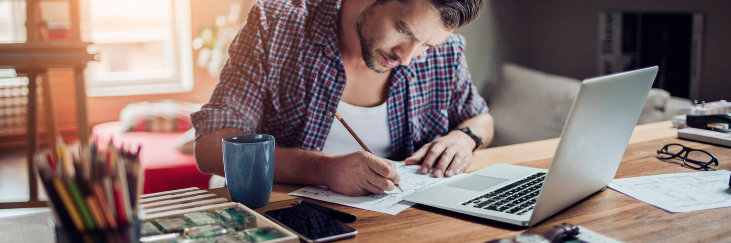 Man writing at a desk