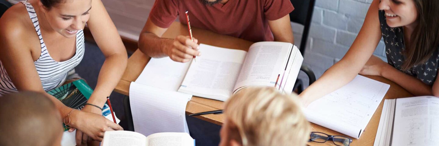 Young college students working together in class