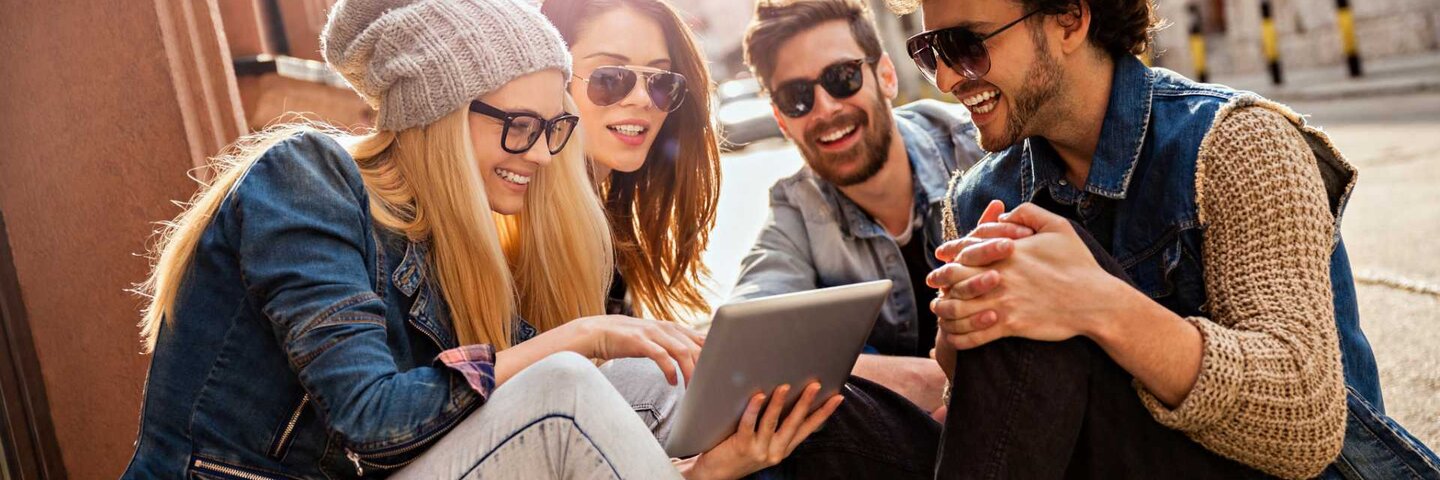 Close up of a friends looking at digital tablet