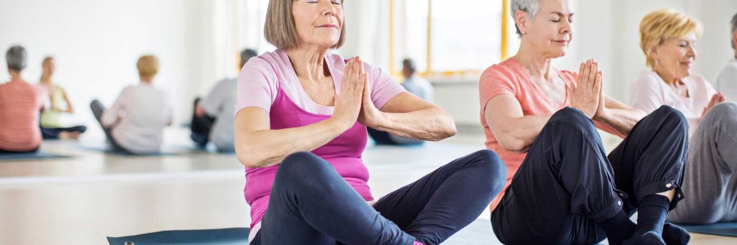 Mature people doing yoga
