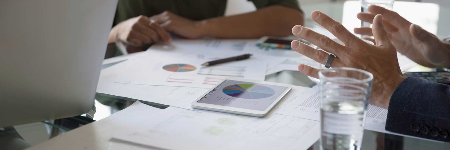Business people reviewing financial data paperwork in conference room meeting