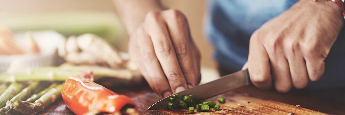 Cropped shot of a man preparing a healthy meal at home