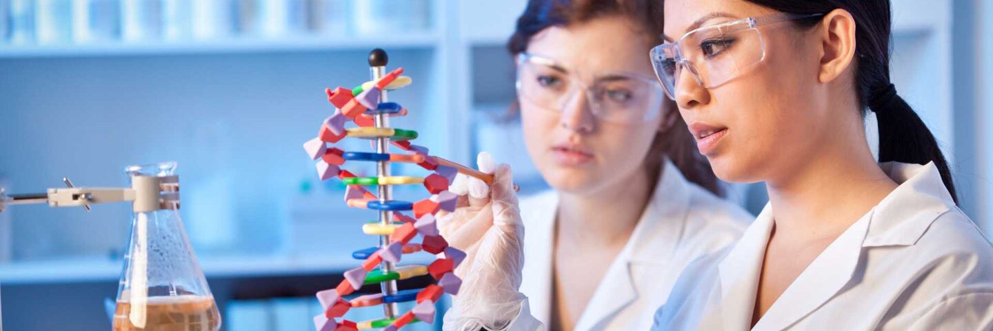 Two Female Genetic Scientists Chemists Working Together in a Laboratory