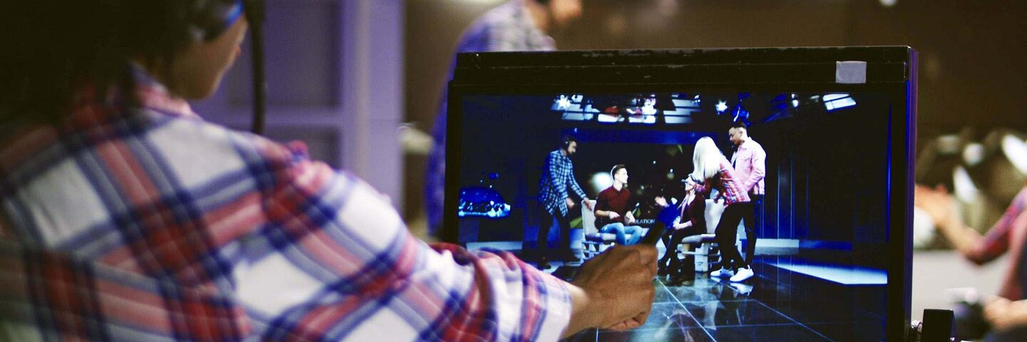 Woman in headset controlling process of shooting TV show