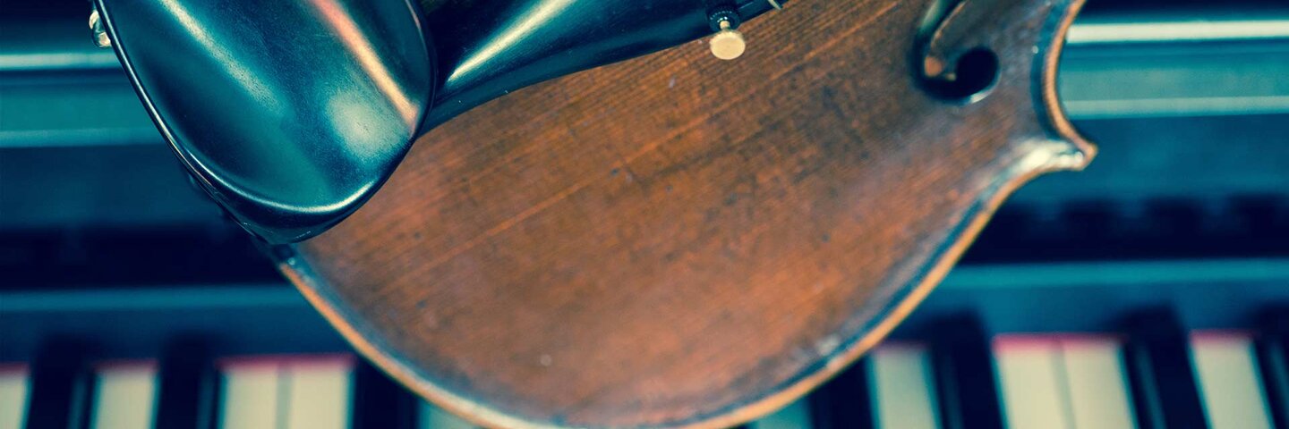 Close-Up Of Violin On Piano Keys