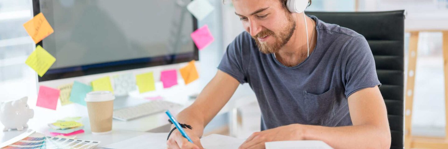 Musician listening to music and working on marketing plan