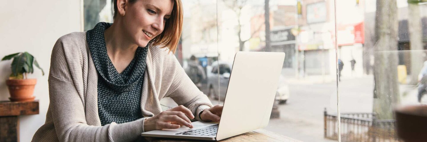woman with laptop at coffee shop