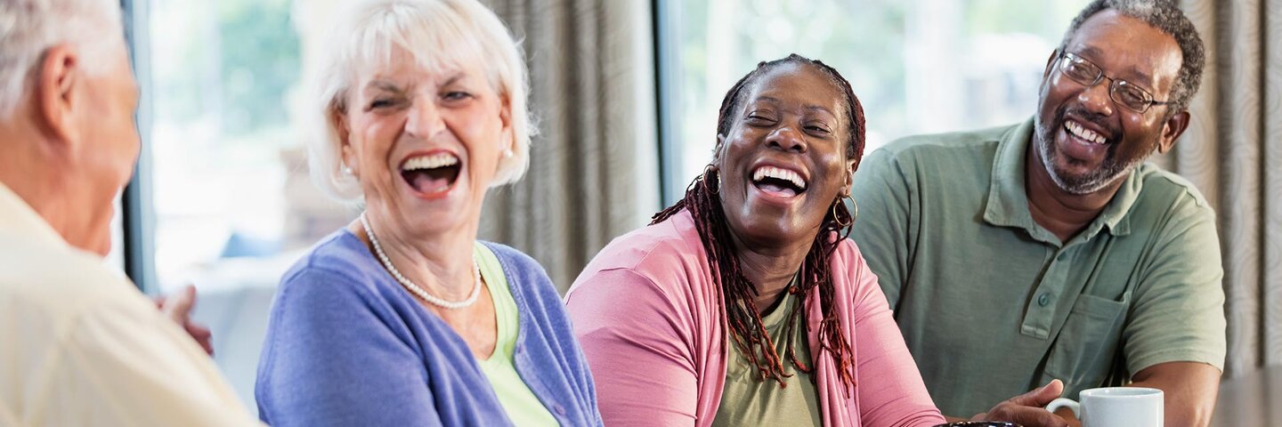 two senior couples at a table drinking coffee