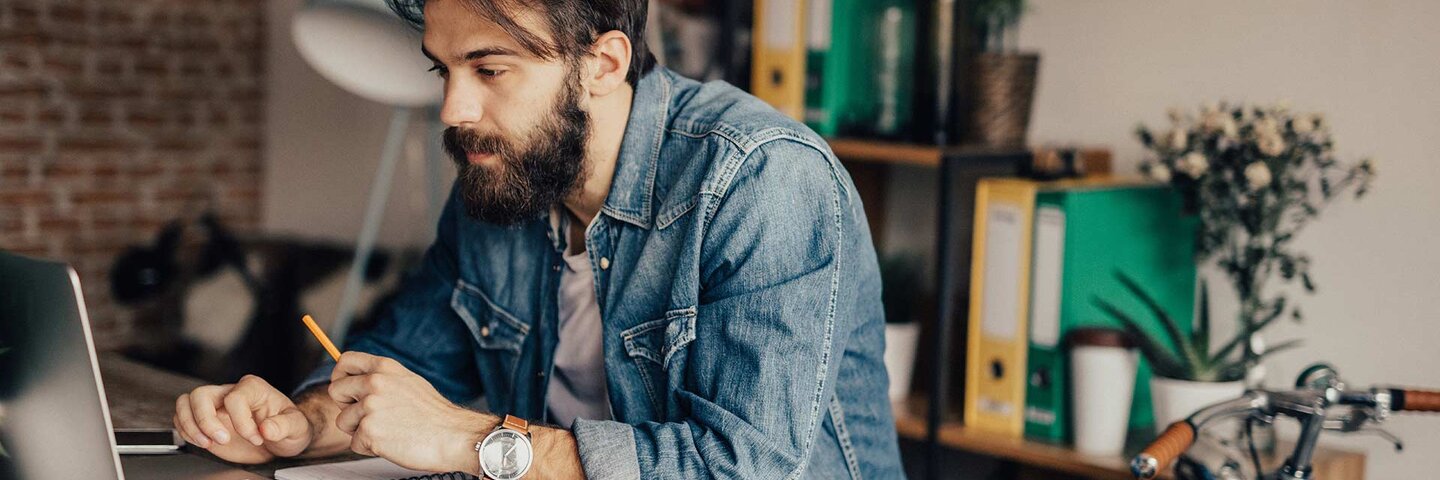 Young man using laptop at home