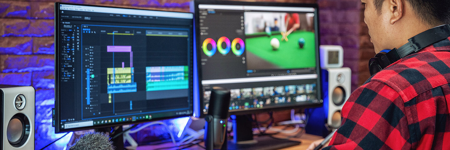 Man color correcting a file on his desktop computer