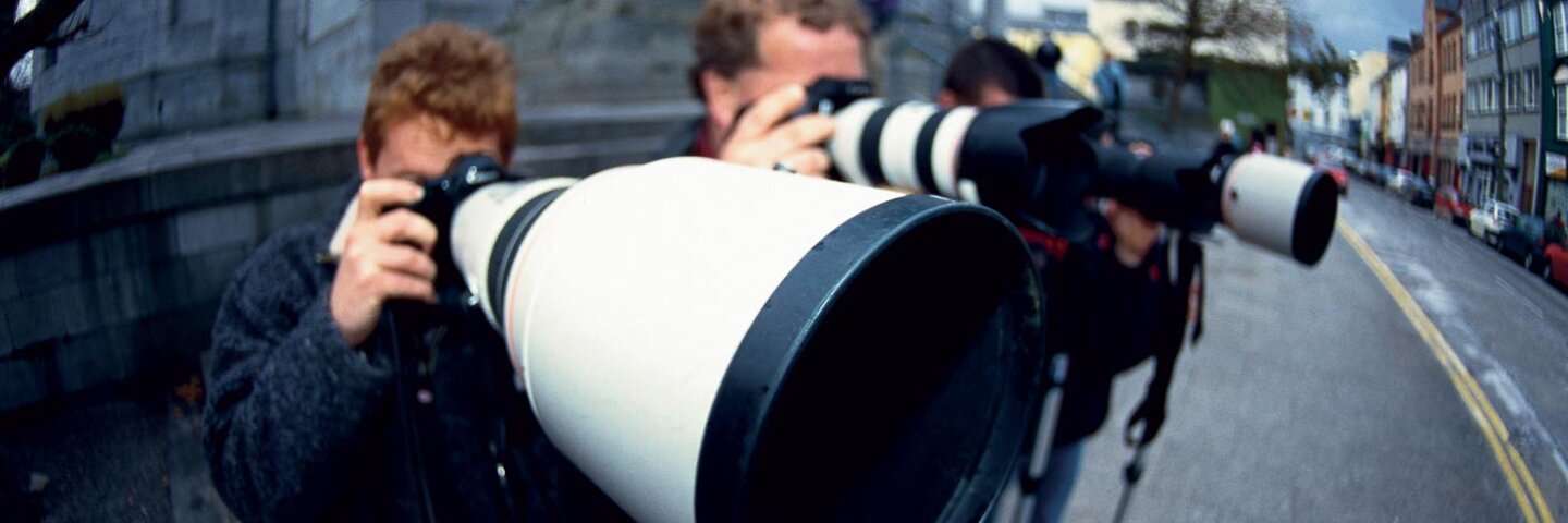 3 photographers looking into their cameras