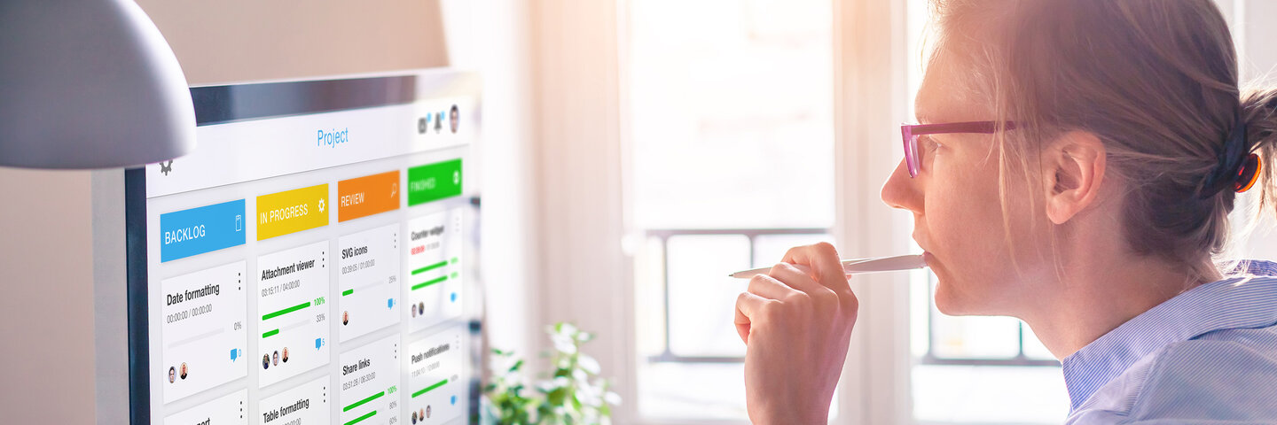 Woman at desk looking at computer screen
