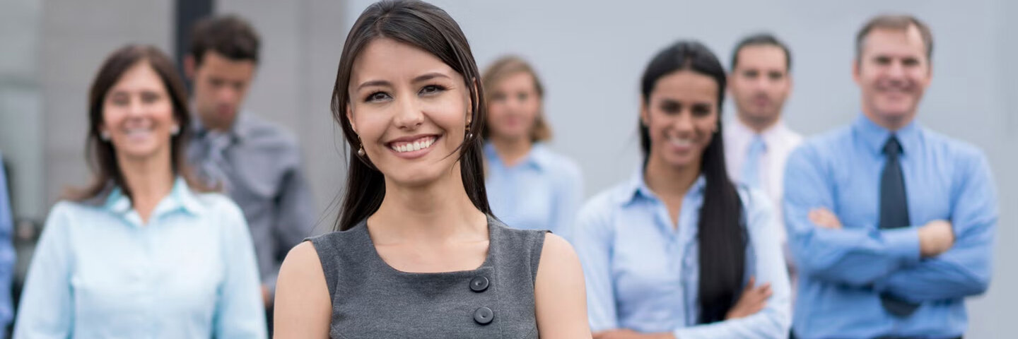 Business woman standing with coworkers