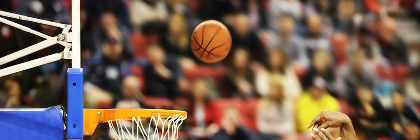 Action shot of a basketball game representing sports management and industry education programs.
