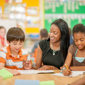 Female teacher with two elementary school children
