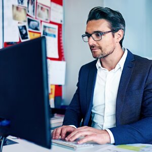man sitting at computer