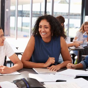 Teacher with students at a table