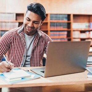 indian man studying with laptop